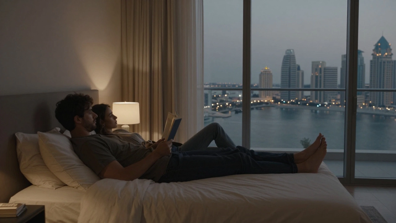 Two people resting peacefully in a luxurious apartment, one reading, the other looking out at the marina.